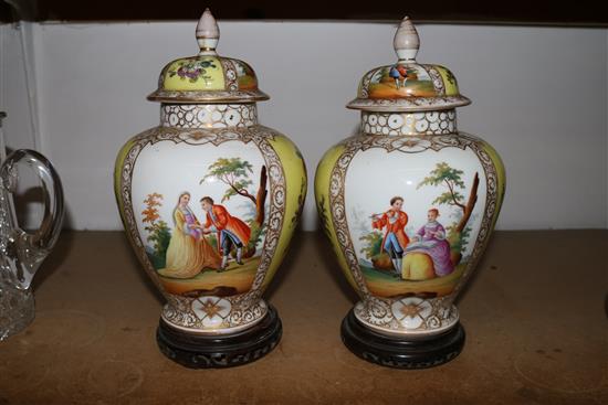 Pair of gilt & figurative decorated lidded Dresden vases on stands